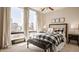 This modern bedroom features a large window, a stylish bed with a patterned comforter, and tasteful decorations at 802 N Meridian St # 103, Indianapolis, IN 46204