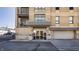 Modern building featuring brick facade, balconies, secure entrance, and convenient garage access at 802 N Meridian St # 103, Indianapolis, IN 46204