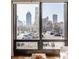 Stunning city view from a large window, showcasing downtown buildings and urban landscape at 802 N Meridian St # 103, Indianapolis, IN 46204