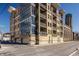 Modern apartment complex featuring a beige brick exterior, large windows, and stylish balconies at 802 N Meridian St # 103, Indianapolis, IN 46204