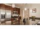 Modern kitchen with stainless steel appliances, granite countertops, and dark wood cabinetry at 802 N Meridian St # 103, Indianapolis, IN 46204