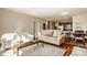 Bright living area with hardwood floors, open to a kitchen, featuring stylish furniture and natural light at 802 N Meridian St # 103, Indianapolis, IN 46204