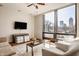 Cozy living room with large windows offering a city view, stylish seating, and modern decor at 802 N Meridian St # 103, Indianapolis, IN 46204