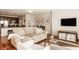 Open living space with hardwood floors, a comfortable sofa, and a view into a modern kitchen at 802 N Meridian St # 103, Indianapolis, IN 46204
