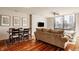 Open-concept living room featuring hardwood floors, modern decor, and a large window with city views at 802 N Meridian St # 103, Indianapolis, IN 46204