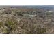This aerial view of the mature community has bare trees and dense woods around waterfront properties at 8172 S Shoreview Dr, Trafalgar, IN 46181