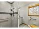Accessible bathroom featuring walk-in shower with grab bars, vanity, and a window for natural light at 8172 S Shoreview Dr, Trafalgar, IN 46181