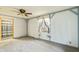 Bedroom featuring a ceiling fan, a window, and light-colored walls with blue trim at 8172 S Shoreview Dr, Trafalgar, IN 46181