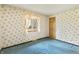 Bedroom featuring floral wallpaper, window with sheer curtains, and light-colored wood door at 8172 S Shoreview Dr, Trafalgar, IN 46181