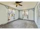 Spacious bedroom featuring a ceiling fan, windows with white curtains and blue trim at 8172 S Shoreview Dr, Trafalgar, IN 46181
