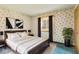 Bedroom with a dark wood frame bed and a window with patterned curtains at 8172 S Shoreview Dr, Trafalgar, IN 46181