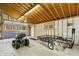 Bright garage with exposed rafter ceiling, featuring ample storage and workspace at 8172 S Shoreview Dr, Trafalgar, IN 46181