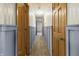 Hallway featuring a light-colored carpet and wainscoting and doors on both sides at 8172 S Shoreview Dr, Trafalgar, IN 46181