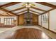 The living room features beamed ceilings, wood accents, a brick fireplace, and lots of natural light at 8172 S Shoreview Dr, Trafalgar, IN 46181