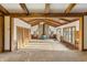 Living room features beamed ceilings, wood accents, a stone fireplace, and lots of natural light at 8172 S Shoreview Dr, Trafalgar, IN 46181