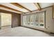 This bright living room is accented by a brick wall and is illuminated by natural light from a large picture window at 8172 S Shoreview Dr, Trafalgar, IN 46181