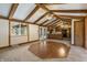This living room features an eye-catching geometric floor, beamed ceilings, and opens to the kitchen at 8172 S Shoreview Dr, Trafalgar, IN 46181