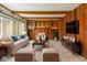 Cozy living room with wood paneled walls, built-in cabinets, and comfortable seating at 8172 S Shoreview Dr, Trafalgar, IN 46181