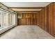 Living room with wood paneling, beamed ceiling, built-in cabinets, and large windows at 8172 S Shoreview Dr, Trafalgar, IN 46181