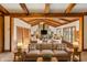 Spacious living room featuring wood beam vaulted ceilings, a stone fireplace, and ample seating at 8172 S Shoreview Dr, Trafalgar, IN 46181