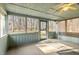 Bright sunroom features large windows that offer panoramic views of the wooded surroundings at 8172 S Shoreview Dr, Trafalgar, IN 46181