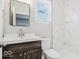 Modern bathroom with walk-in shower, a wood vanity, and a stylish mirror at 929 N Beville Ave, Indianapolis, IN 46201