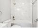 Modern bathroom with marble wall tiles and a bathtub and shower combination at 929 N Beville Ave, Indianapolis, IN 46201