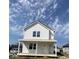 New construction two-story home with white vertical siding and a welcoming front porch at 929 N Beville Ave, Indianapolis, IN 46201