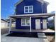 Charming two-story home with a bright blue exterior and covered porch entrance at 929 N Beville Ave, Indianapolis, IN 46201