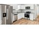 Modern kitchen with stainless steel appliances, white cabinets, and granite countertops at 929 N Beville Ave, Indianapolis, IN 46201