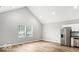 Bright living room with vaulted ceiling and large windows, with an adjacent kitchen at 929 N Beville Ave, Indianapolis, IN 46201