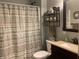 Bathroom featuring a shower with a stylish striped curtain and a vanity with modern fixtures and a decorative shelf at 1002 Plummer Rd, Martinsville, IN 46151