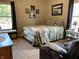 Bright bedroom with natural light, comfortable bed with a quilt, and cozy seating area by the window at 1002 Plummer Rd, Martinsville, IN 46151