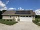 Exterior view of a home featuring solar panels, an attached garage, and well-manicured landscaping at 1002 Plummer Rd, Martinsville, IN 46151