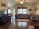Spacious living room featuring hardwood floors, neutral decor, comfortable seating, and ample natural light at 1002 Plummer Rd, Martinsville, IN 46151