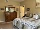 Main bedroom featuring a large dresser, a comfortable bed with decorative pillows, and warm lighting at 1002 Plummer Rd, Martinsville, IN 46151