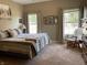 Comfortable main bedroom with neutral tones, natural light, and a cozy rocking chair at 1002 Plummer Rd, Martinsville, IN 46151