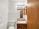 Neutral bathroom features a wood vanity, bright lighting, and white fixtures at 1035 Ina Cir, Franklin, IN 46131