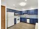 Functional kitchen showcases blue cabinets, modern lighting, efficient layout and clean white appliances at 1035 Ina Cir, Franklin, IN 46131