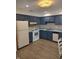 Well-lit kitchen featuring blue cabinets, modern appliances, and updated countertops, perfect for cooking and entertaining at 1035 Ina Cir, Franklin, IN 46131