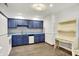 Efficient kitchen featuring blue cabinets, modern appliances, wood-look floors, and functional workspace at 1035 Ina Cir, Franklin, IN 46131