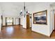 The open living space showcases a chandelier, access to kitchen, and natural light from the adjacent rooms at 1035 Ina Cir, Franklin, IN 46131