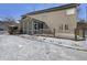 Back exterior of a two-story home with a screened in porch and small deck surrounded by snow at 1059 Sugar Maple Dr, Greenwood, IN 46143