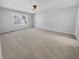 Bright, spacious bedroom with neutral carpet and a large window at 1059 Sugar Maple Dr, Greenwood, IN 46143