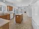Open kitchen with island, oak cabinets, and modern appliances overlooking a living room with fireplace at 1059 Sugar Maple Dr, Greenwood, IN 46143