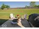 Outdoor patio with fire pit and backyard for entertaining guests at 11026 Cool Winds Way, Fishers, IN 46037