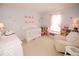 Charming Bedroom with a white crib, a cozy chair, and a playful decor perfect for a little one at 11026 Cool Winds Way, Fishers, IN 46037
