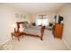 Cozy bedroom featuring a sleigh bed, soft carpet, and comforting natural light streaming through the window at 11026 Cool Winds Way, Fishers, IN 46037