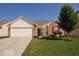 Charming single-story home featuring a well-manicured lawn, attached two-car garage, and a welcoming front entrance at 11026 Cool Winds Way, Fishers, IN 46037