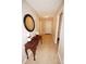 Inviting hallway featuring neutral walls, tile floors, a decorative table with a mirror, and access to other rooms at 11026 Cool Winds Way, Fishers, IN 46037